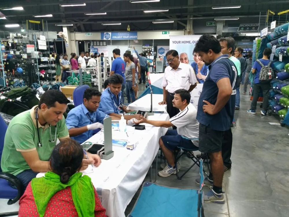 Healthcare professionals performing health checks at a corporate health camp