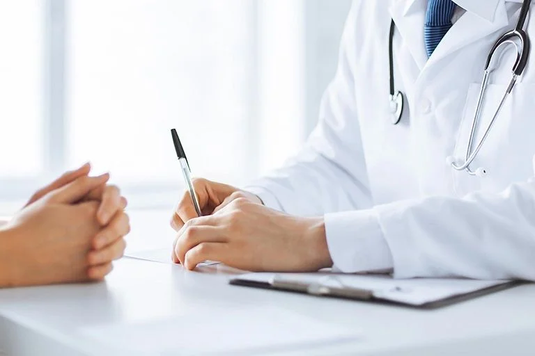 A doctor discussing and documenting a pre-employment health check
